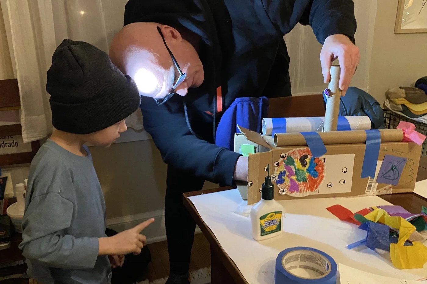 Karl Ring building a cardboard robot with his nephew Noah